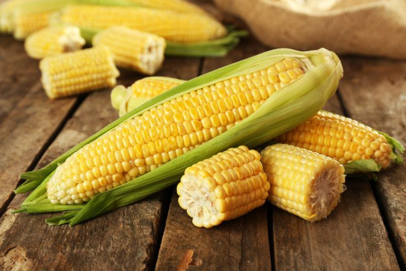 A selection of corn on a wooden table