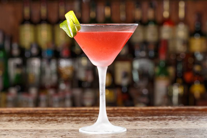 A cosmopolitan cocktail against an out-of-focus bar