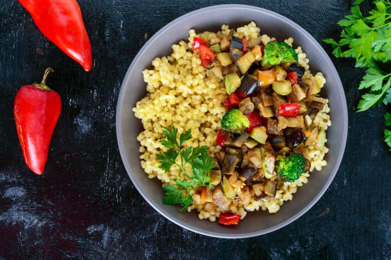 A bowl of couscous with various toppings