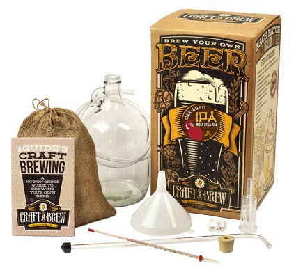 Small brewing kit including a box, funnel, ingredients, tube and glassware. 