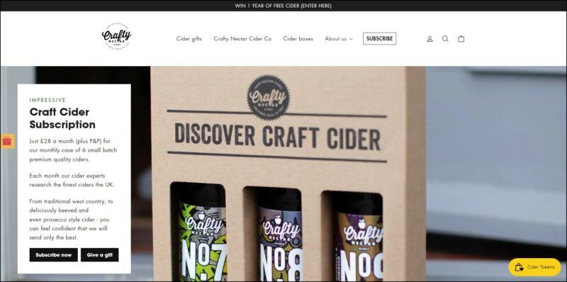 screenshot of Crafty Nectar Craft Cider Subscription's web page, with black announcement bar on top followed by a white header bearing the website's name and main menu, the page is showing a large image banner depicting the company's products in special carton box, text overlay of details about the cider subscription.