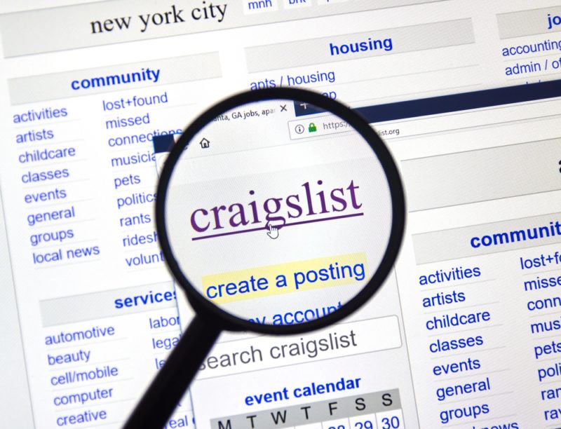 A magnifying glass looking at the Craigslist website