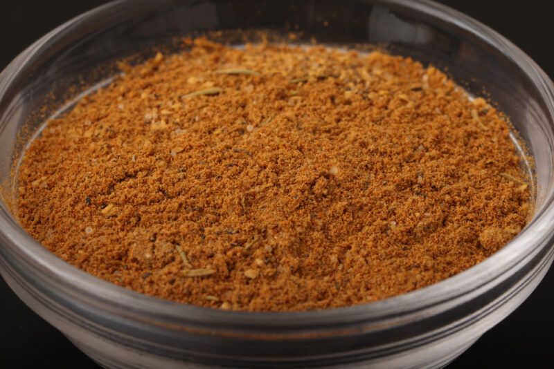 closeup image of a clear glass bowl with Creole seasoning