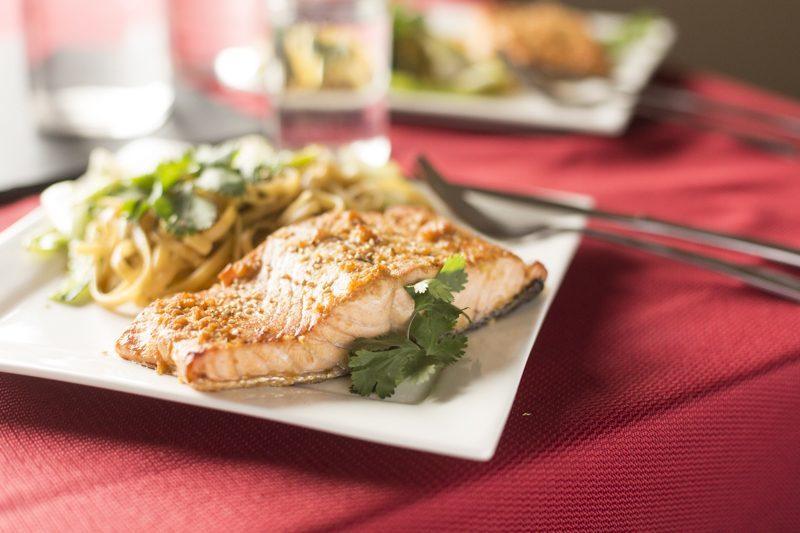 Crispy Asian Salmon Noodle Stir Fry Detail Shot Red Tablecloth Cilantro