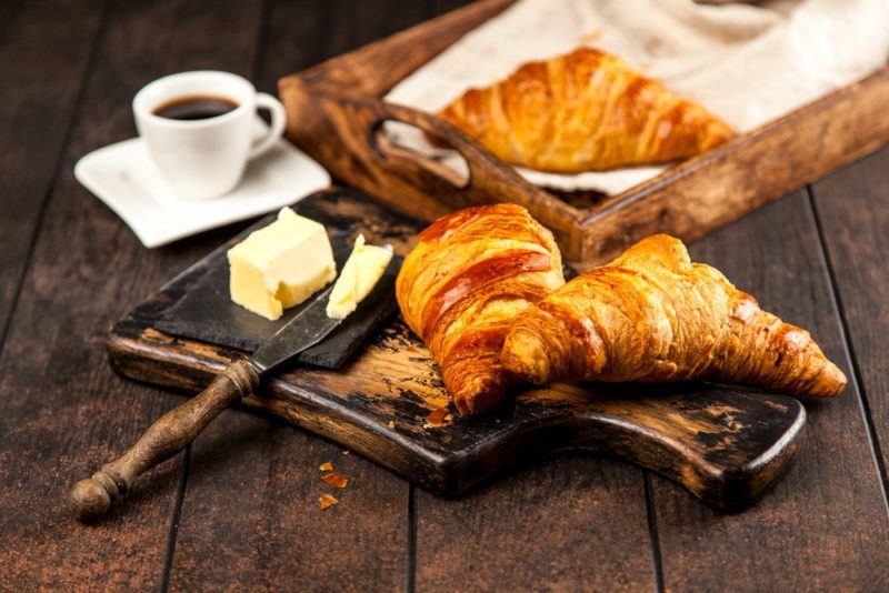 Croissants with butter and coffee on a table