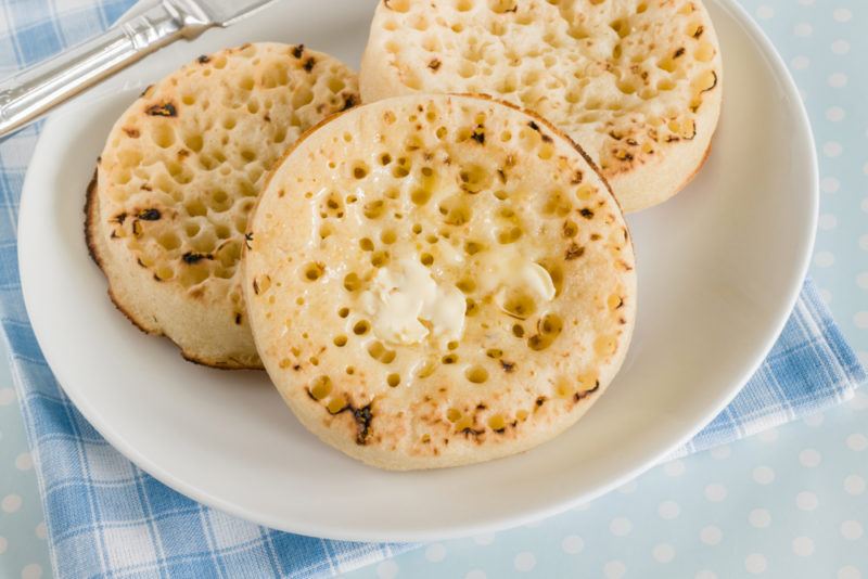 A white plate with three crumpets