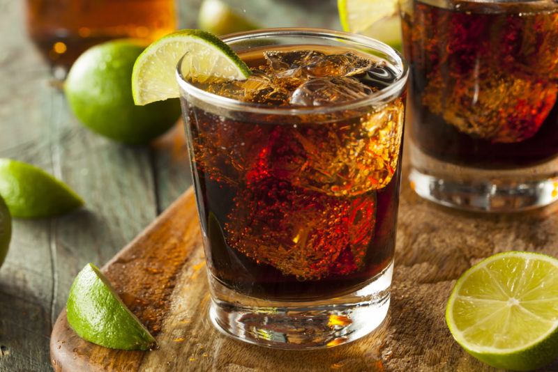 Two glasses of a Cuba libre with lime wedges