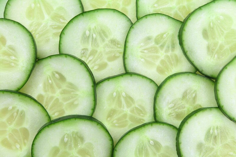 This photo shows an overhead view of several slices of cucumber.