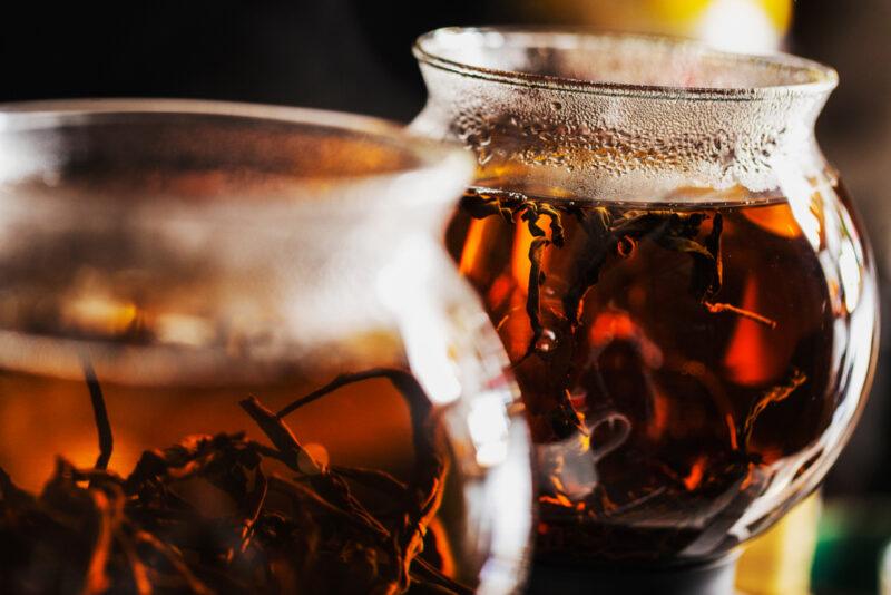 A close up images of two glass jars being used to make cups of tea