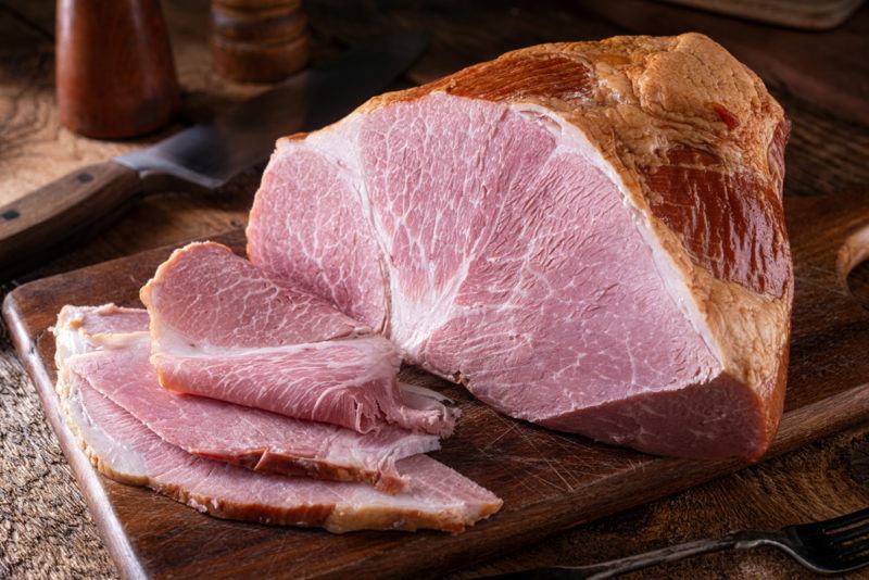 Brined ham that has been sliced on a board