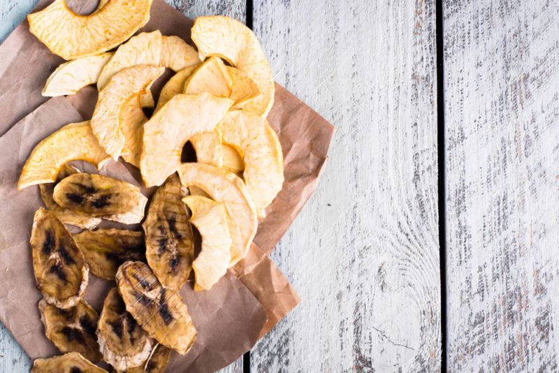 Dried apples and bananas on brown paper