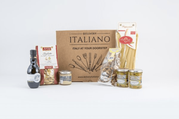 A selection of Italian food and a box against a white background