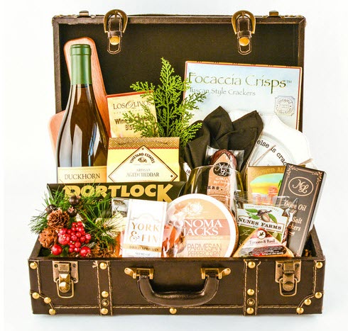 Deluxe Chardonnay Duckhorn Wine Treasure Chest | Food For Net Suitcase with a selection of snacks, greenery and other items.