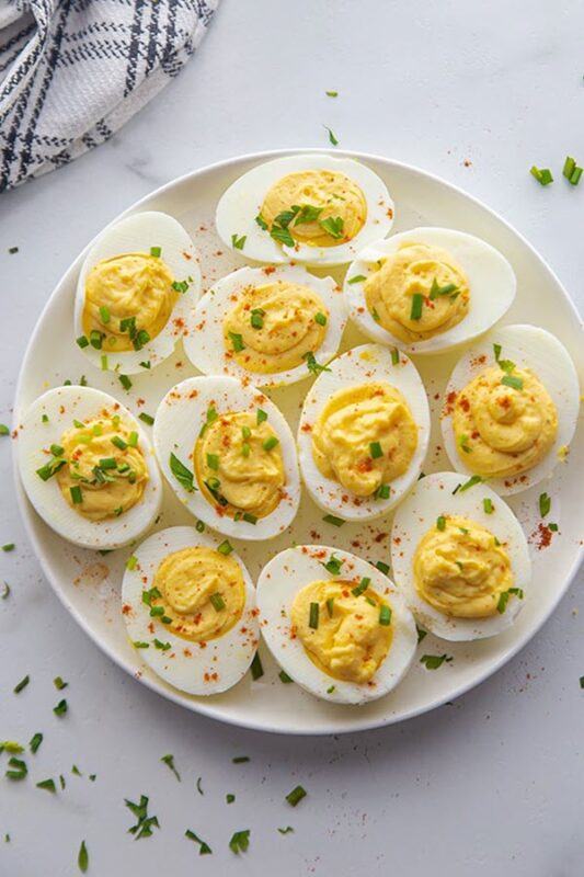 A circular plate with a dozen or so pickled eggs