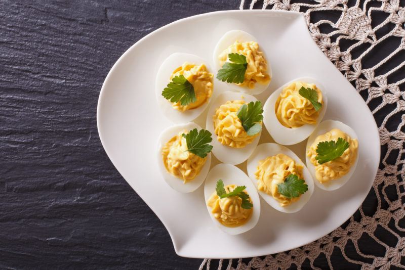 A white dish with deviled eggs