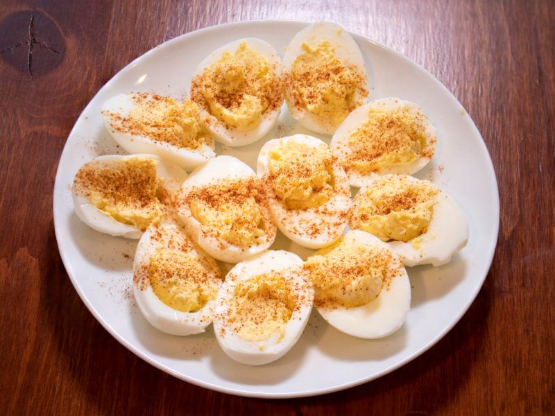 Deviled eggs with turmeric sprinked on top of them