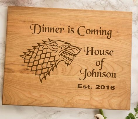 Dinner Is Coming | Food For Net A cutting board with 'Dinner is Coming' and Game of Thrones information on it.