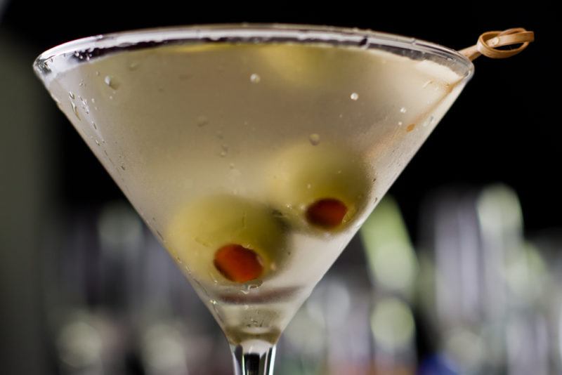 A dirty martini with two olives