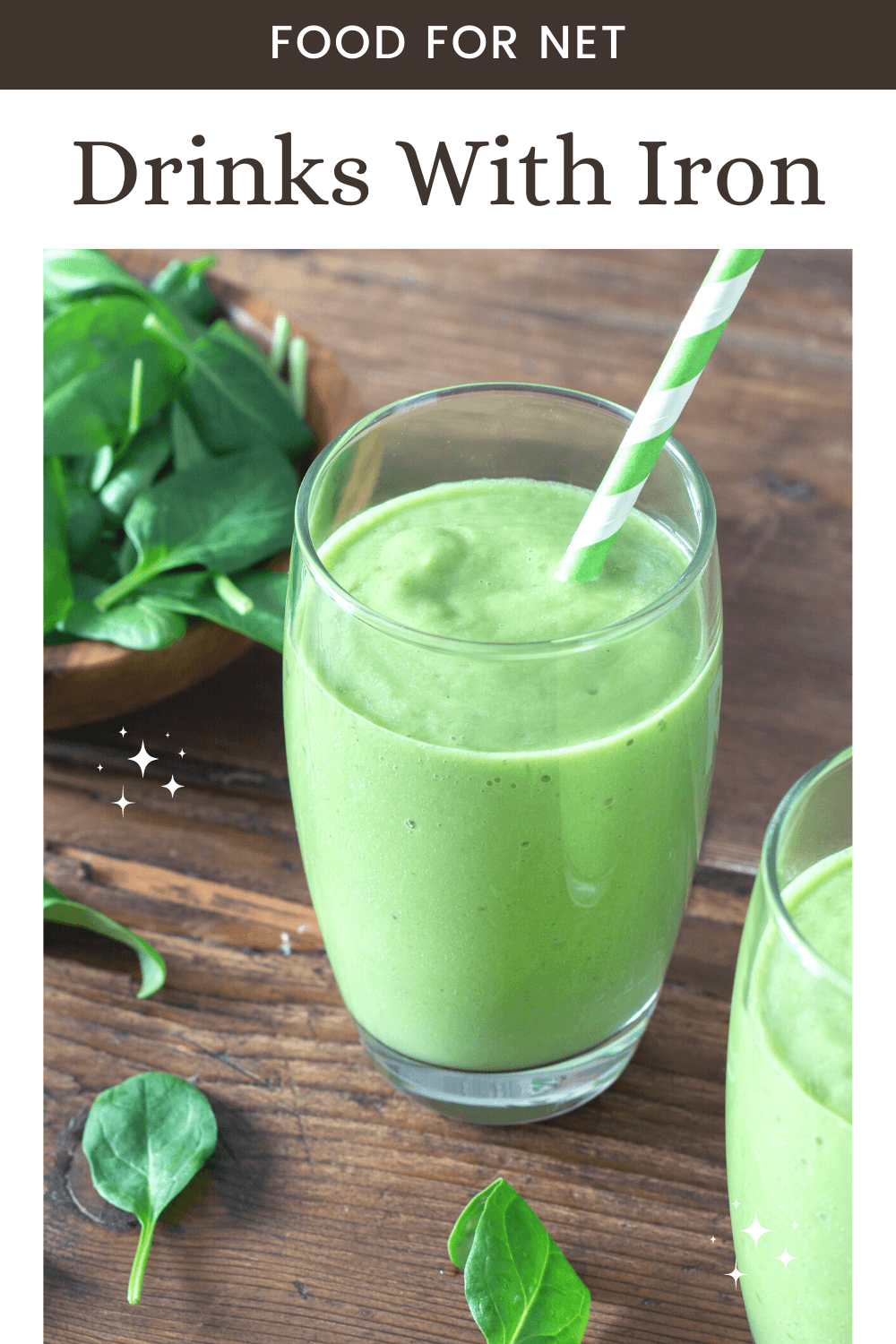 Drinks With Iron. A wooden table with two glasses of a spinach smoothie, next to a bowl of spinach