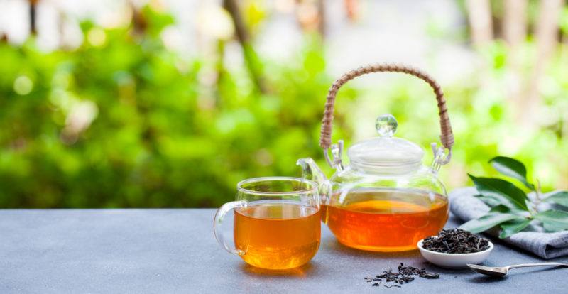 A glass teapot and a glass mug of earl gray tea