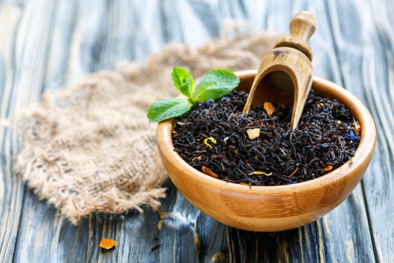 A bowl of Earl gray tea leaves with a scoop