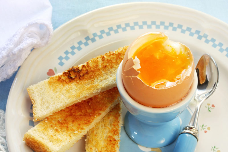 Sliced egg soldiers and a runny egg in an egg cup