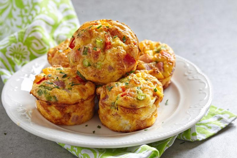 A small pile of egg muffins on a white plate