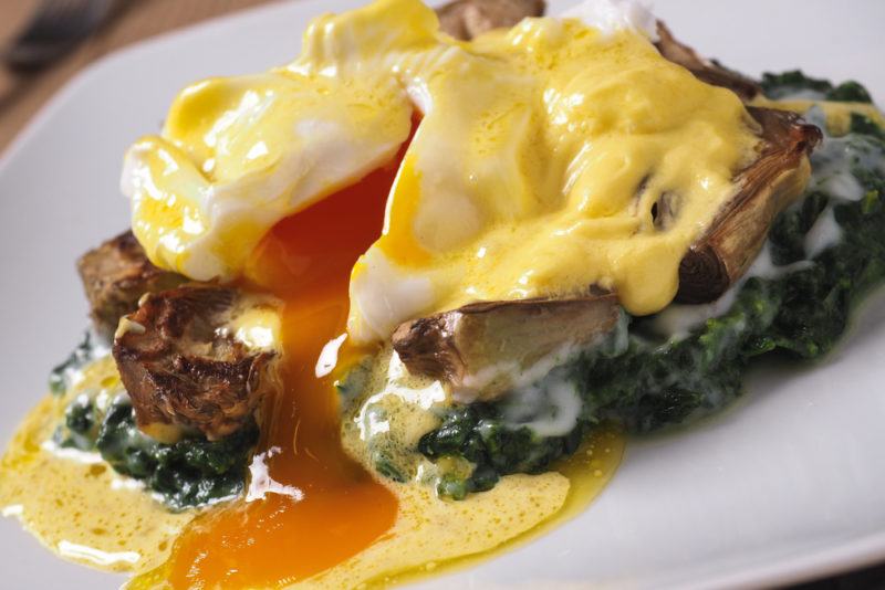 A breakfast in New Orleans that includes eggs benedict on creamed spinach