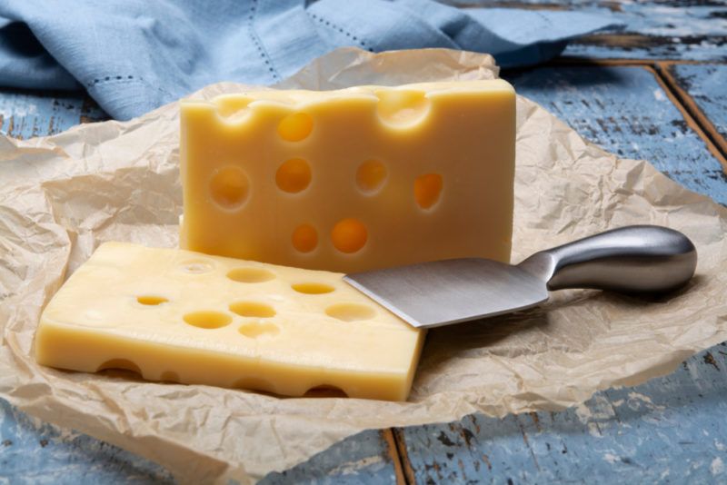 Emmental cheese on paper and a wooden table