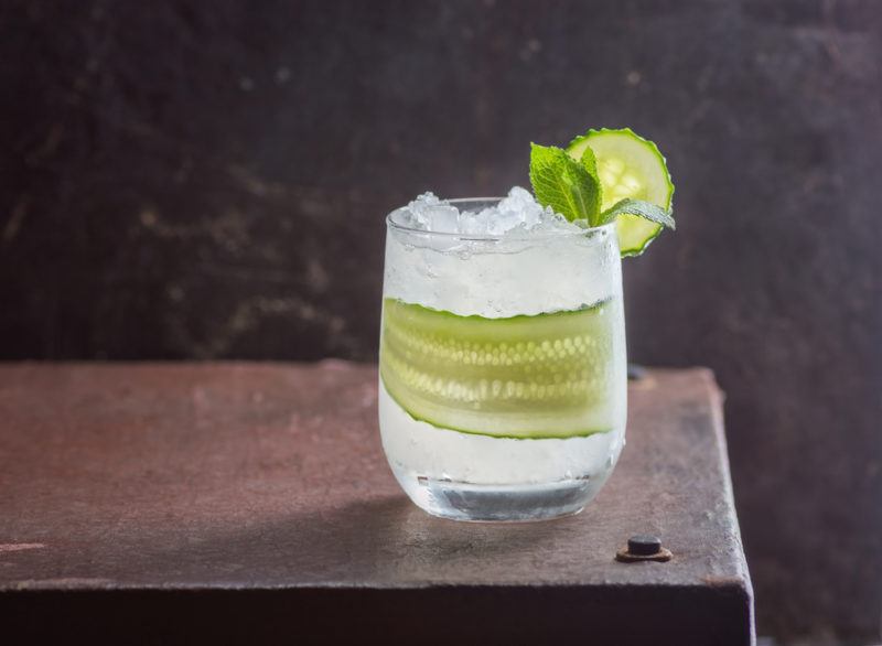 An English Garden Cocktail with a slice of cucumber and shaved ice