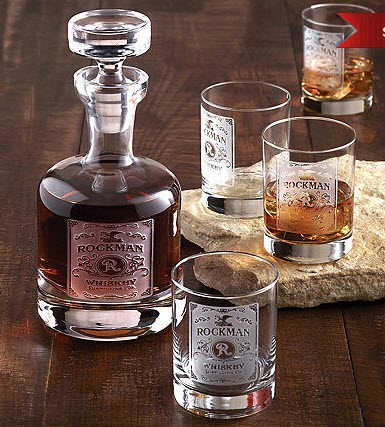 Etched Whiskey Label Decanter And Glasses Set | Food For Net A wooden table with a whiskey decanter and four glasses.