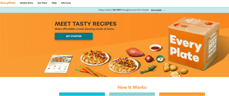 A website screenshot from EveryPlate, showing a bright orange background, a cardboard box, and many types of food