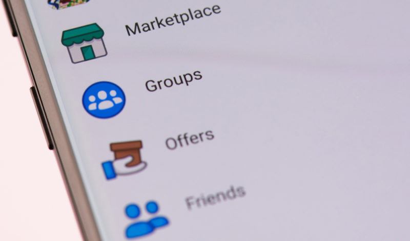 A close up image of a list including Facebook Marketplace and Facebook Groups on an app