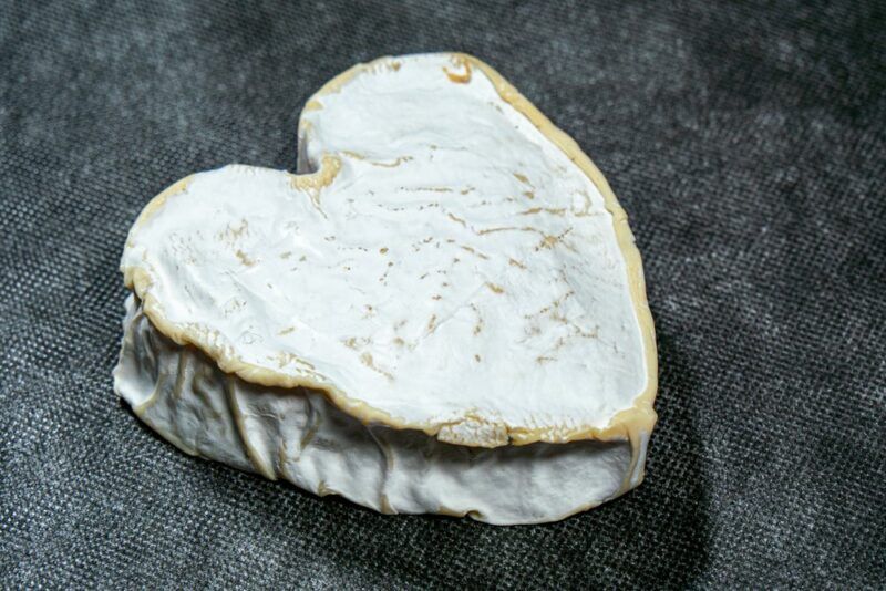 A gray table with neufchâtel cheese in the shape of a heart