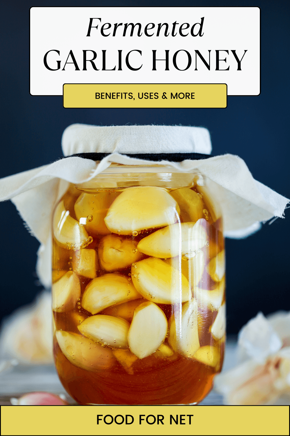 A large jar containing fermented garlic honey on a table