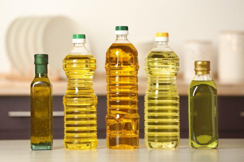 Five bottles of different types of oil in a row