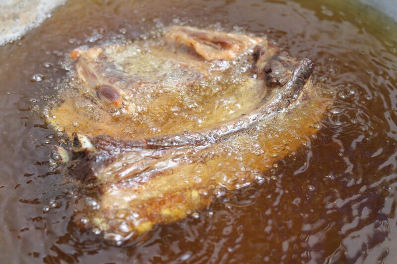 Pork belly pieces being deep fried for a second time