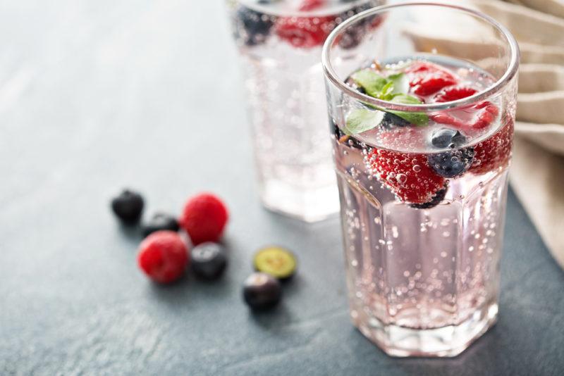 Glasses of flavored seltzer with berries