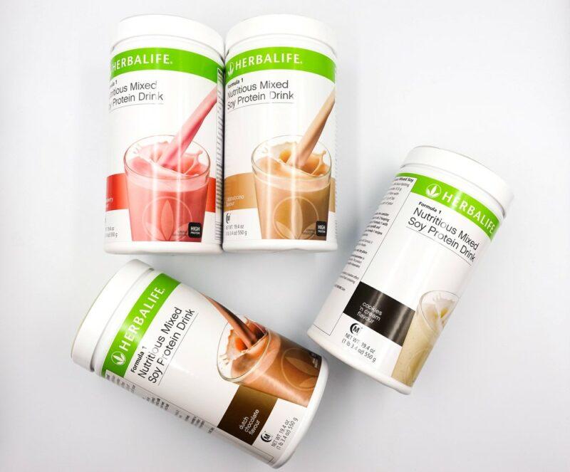 Three Herbalife shakes against a table