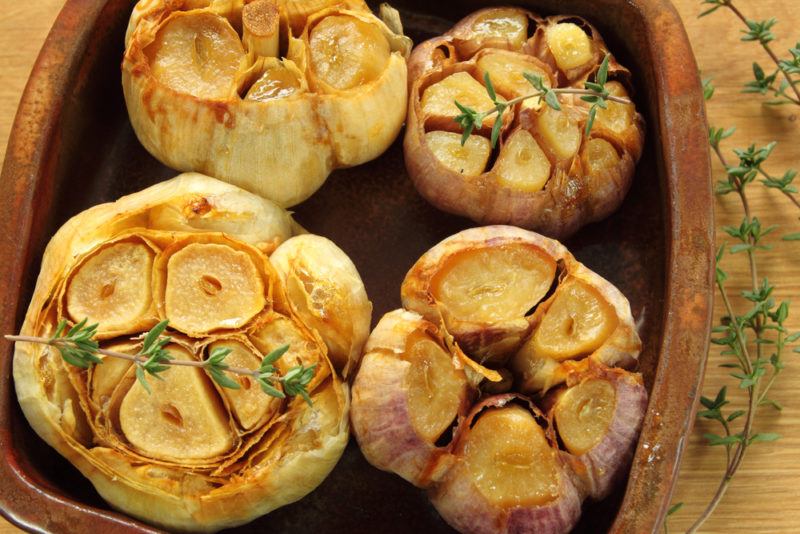 Four heads of garlic that have been roasted