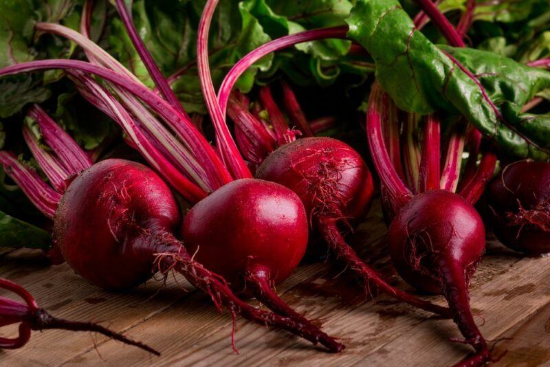 Fresh beets on a table with leaves still attached