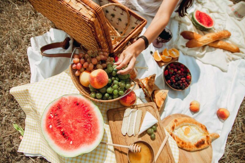 A picnic with a variety of fresh ingredients and half a watermelon