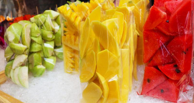 Packets of fresh fruit on an ice cart