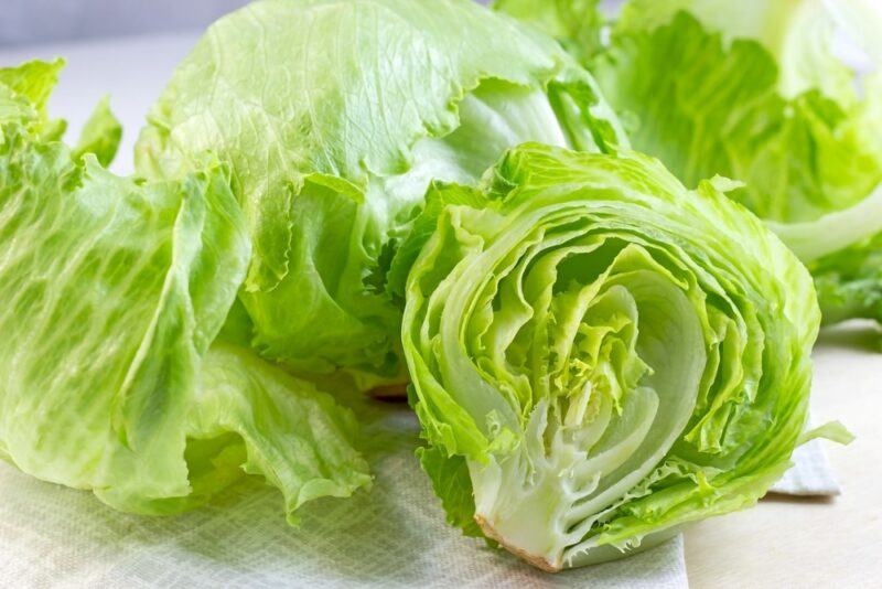 A table containing fresh iceberg lettuce on a table