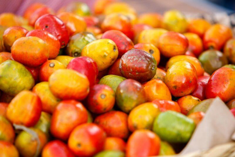 A large dish of brightly colored jacote fruits in different colors