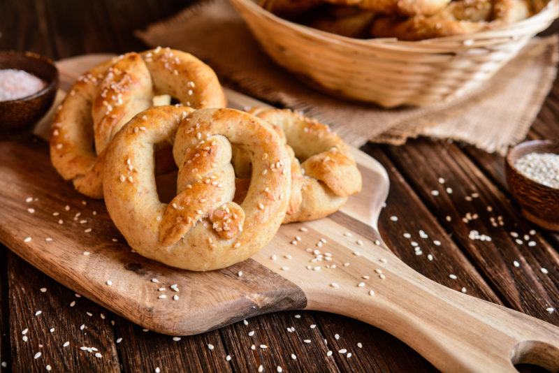 A wooden board with some fresh pretzels