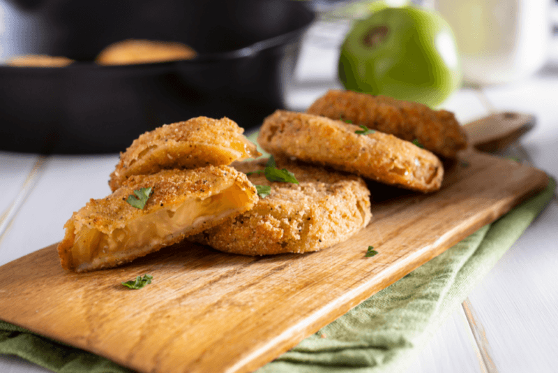 A wooden board with fried green tomatoes