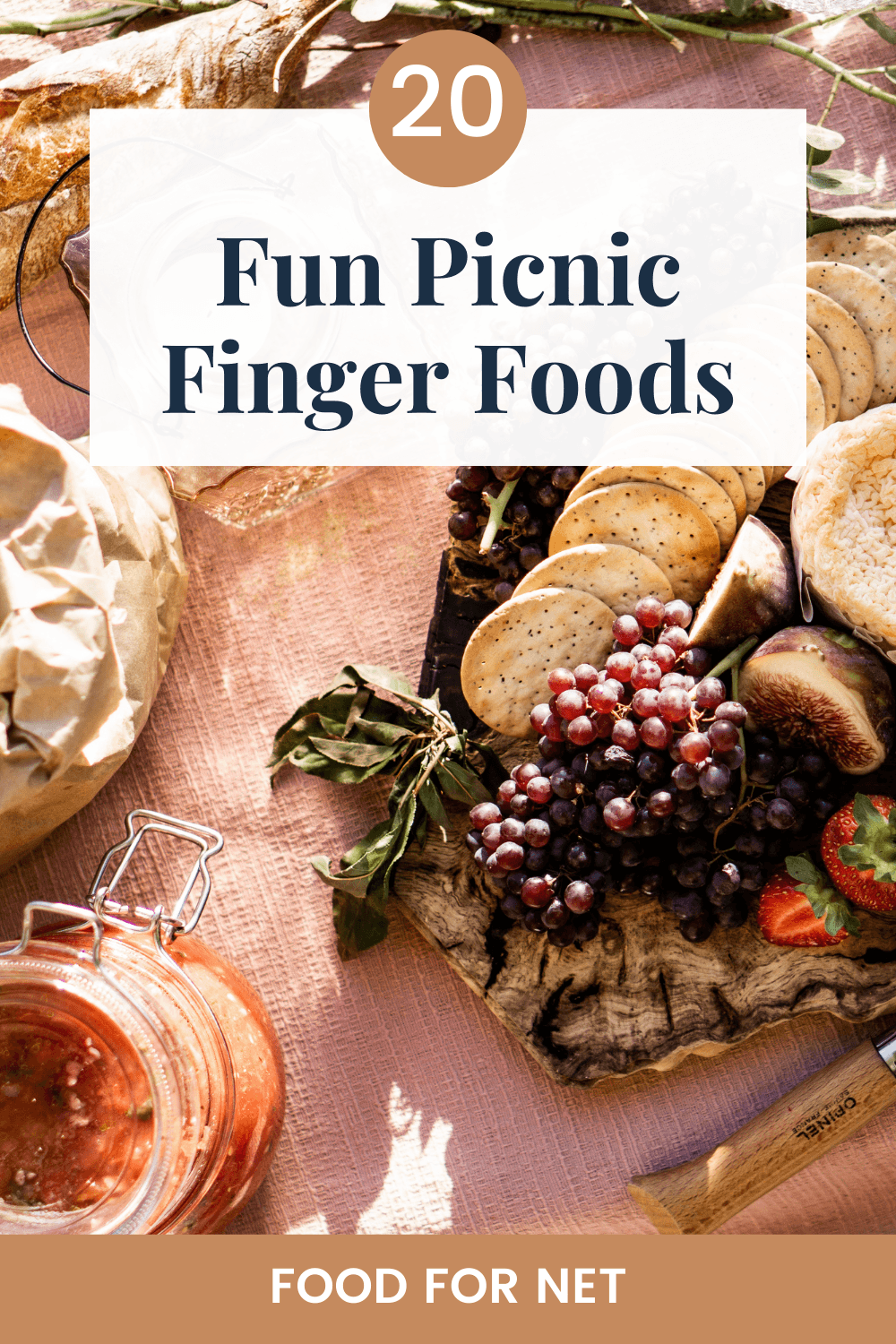 A selection of finger foods for a picnic, including crackers, nuts, fruit and the like