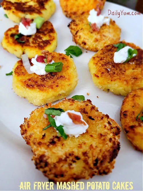 Eight garlic parmesan air fryer mashed potato cakes with sour cream on the top