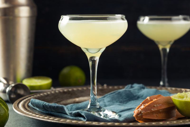 Two glasses of a gimlet cocktail on a bar